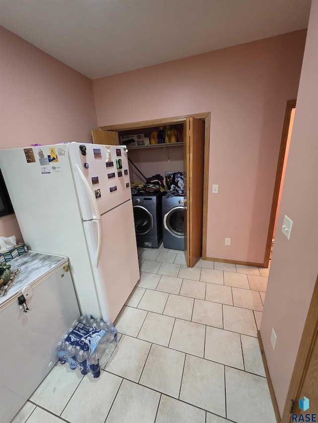 3333 W Ralph Rogers Rd, Sioux Falls, SD 57108 - kitchen featuring washer / dryer, freestanding refrigerator, and light tile patterned flooring