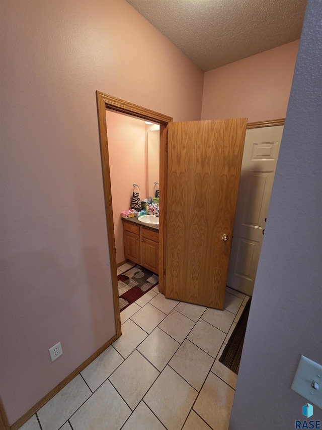 3333 W Ralph Rogers Rd, Sioux Falls, SD 57108 - corridor with a textured ceiling and light tile patterned floors