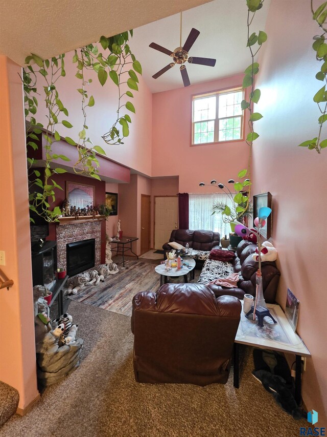 3333 W Ralph Rogers Rd, Sioux Falls, SD 57108 - living room with a ceiling fan, a fireplace, and a towering ceiling