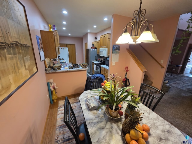 3333 W Ralph Rogers Rd, Sioux Falls, SD 57108 - dining area with a chandelier, recessed lighting, and stairs