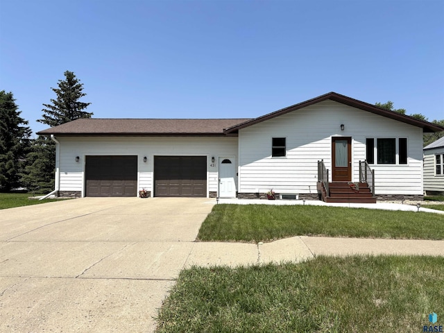 421 E 2nd St, Miller, SD 57362 - view of front of home featuring a garage, concrete driveway, entry steps, and a front yard