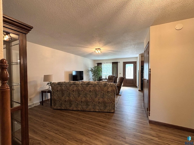 421 E 2nd St, Miller, SD 57362 - living area with a textured ceiling and dark wood-style flooring