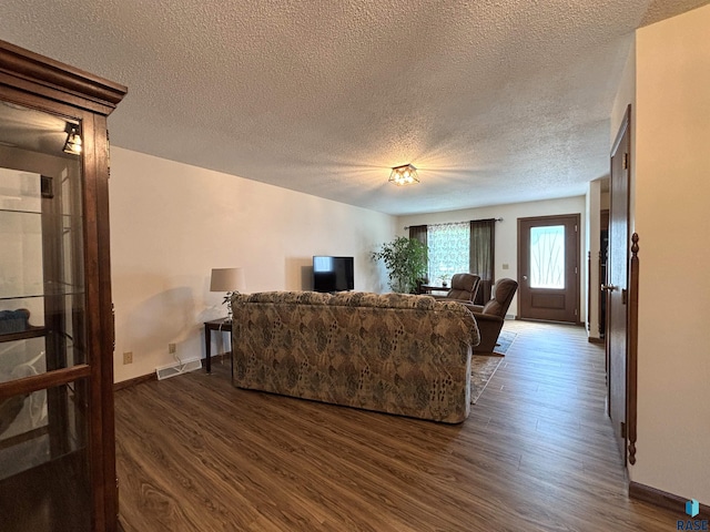 421 E 2nd St, Miller, SD 57362 - living area with dark wood-type flooring and a textured ceiling