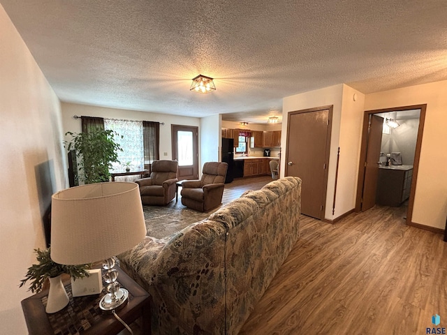 421 E 2nd St, Miller, SD 57362 - living area featuring light wood finished floors and a textured ceiling