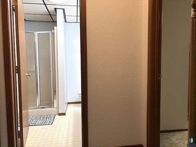 421 E 2nd St, Miller, SD 57362 - hallway featuring a paneled ceiling, tile patterned floors, and a textured wall