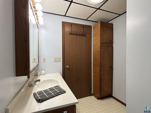 421 E 2nd St, Miller, SD 57362 - bathroom with a drop ceiling, tile patterned floors, and vanity