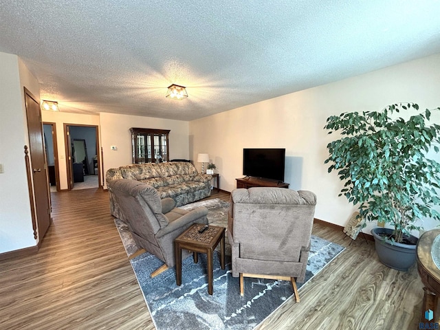 421 E 2nd St, Miller, SD 57362 - living room featuring wood finished floors and a textured ceiling