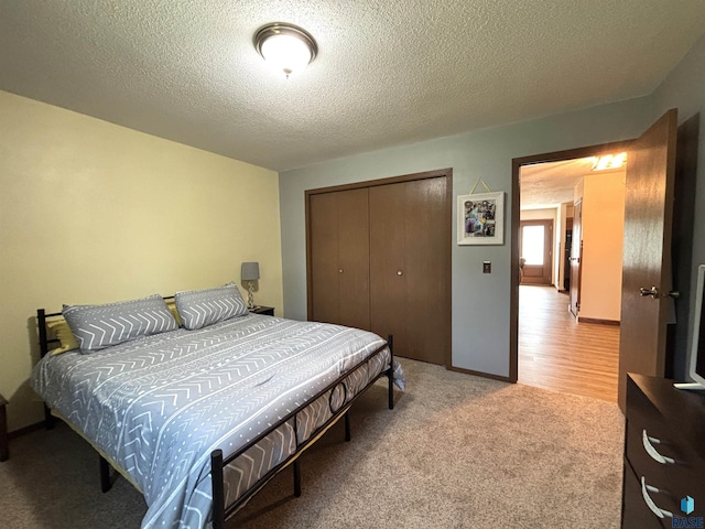 421 E 2nd St, Miller, SD 57362 - carpeted bedroom featuring a closet and a textured ceiling