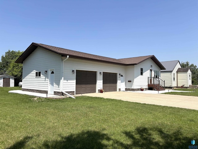 421 E 2nd St, Miller, SD 57362 - view of home's exterior with a storage unit, a lawn, an attached garage, and concrete driveway