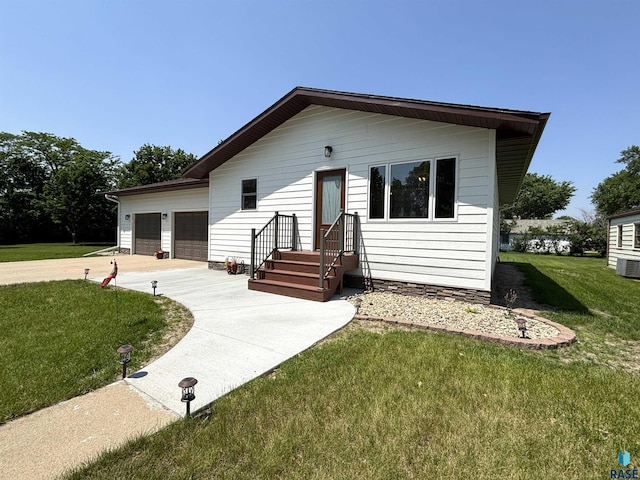 421 E 2nd St, Miller, SD 57362 - view of front of property featuring a garage, a front yard, and driveway