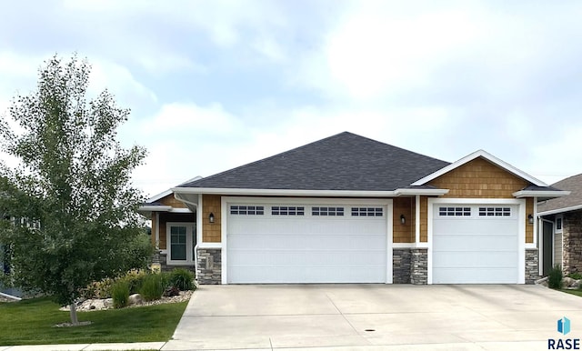 8617 W Bryggen Ct, Sioux Falls, SD 57107 - craftsman house with stone siding, a garage, concrete driveway, and a shingled roof