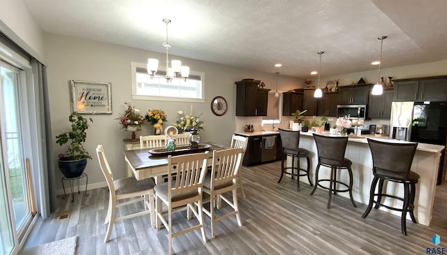 8617 W Bryggen Ct, Sioux Falls, SD 57107 - dining space featuring plenty of natural light, a chandelier, light wood-style flooring, and recessed lighting