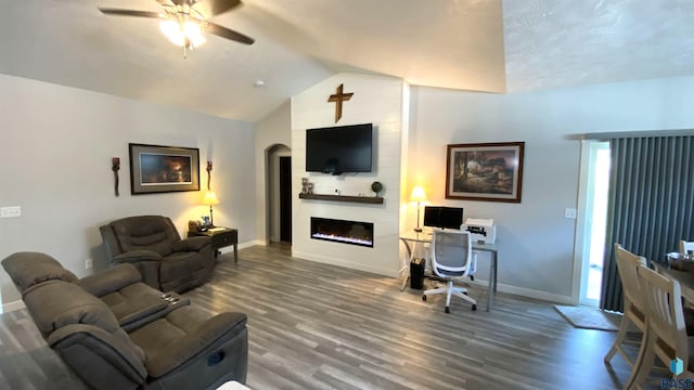 8617 W Bryggen Ct, Sioux Falls, SD 57107 - living area featuring a ceiling fan, wood finished floors, a large fireplace, lofted ceiling, and arched walkways