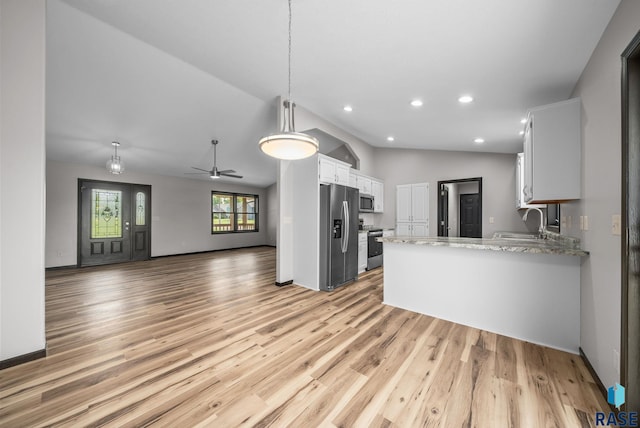 301 W 6th St, Crooks, SD 57020 - kitchen featuring appliances with stainless steel finishes, lofted ceiling, a peninsula, light wood-style floors, and open floor plan