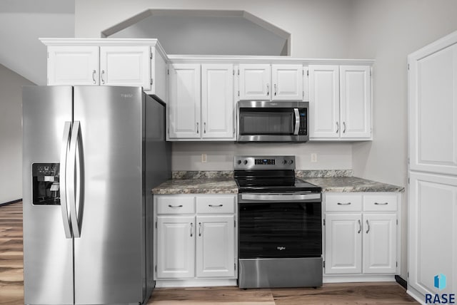 301 W 6th St, Crooks, SD 57020 - kitchen with stainless steel appliances, white cabinets, light wood-style floors, and light stone countertops