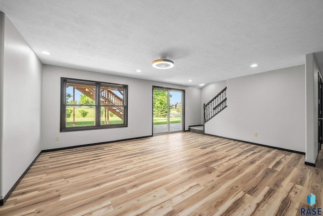301 W 6th St, Crooks, SD 57020 - unfurnished room with stairs, light wood finished floors, recessed lighting, and a textured ceiling