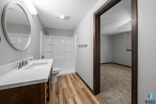 301 W 6th St, Crooks, SD 57020 - bathroom featuring a walk in shower, vanity, and wood finished floors