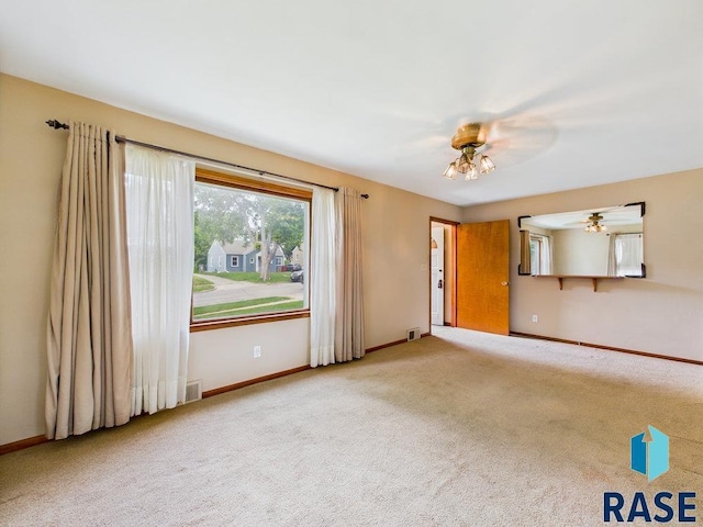 1721 W 11th St, Sioux Falls, SD 57104 - unfurnished living room featuring carpet floors and a ceiling fan