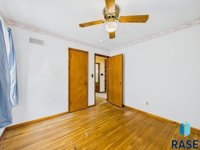 1721 W 11th St, Sioux Falls, SD 57104 - unfurnished bedroom featuring wood-type flooring and ceiling fan