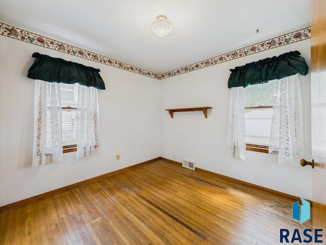 1721 W 11th St, Sioux Falls, SD 57104 - unfurnished room featuring hardwood / wood-style flooring and baseboards