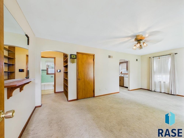 1721 W 11th St, Sioux Falls, SD 57104 - unfurnished living room with arched walkways, light carpet, and plenty of natural light