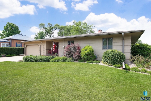 429 S Elm St, Lennox, SD 57039 - ranch-style home featuring concrete driveway, a garage, a chimney, and a front lawn