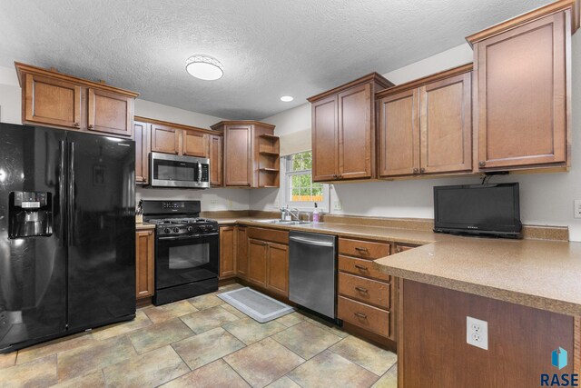 2424 S Main Ave, Sioux Falls, SD 57105 - kitchen with black appliances, open shelves, brown cabinetry, recessed lighting, and a textured ceiling