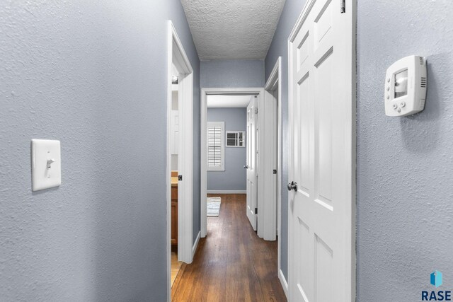 2424 S Main Ave, Sioux Falls, SD 57105 - corridor featuring a textured wall, wood finished floors, and a textured ceiling