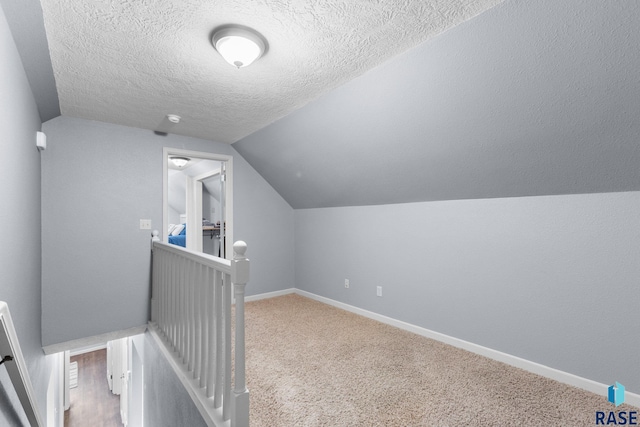 2424 S Main Ave, Sioux Falls, SD 57105 - bonus room featuring lofted ceiling, a textured ceiling, and carpet floors