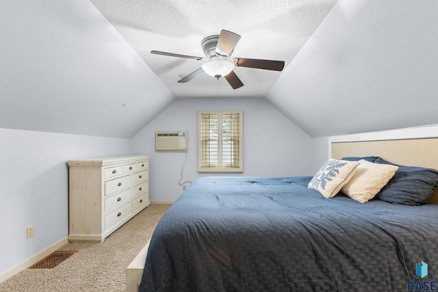 2424 S Main Ave, Sioux Falls, SD 57105 - bedroom featuring an AC wall unit, light colored carpet, lofted ceiling, and a ceiling fan