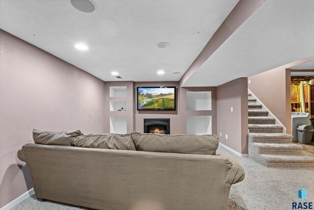 2424 S Main Ave, Sioux Falls, SD 57105 - carpeted living area with stairway, a lit fireplace, washer / clothes dryer, and recessed lighting