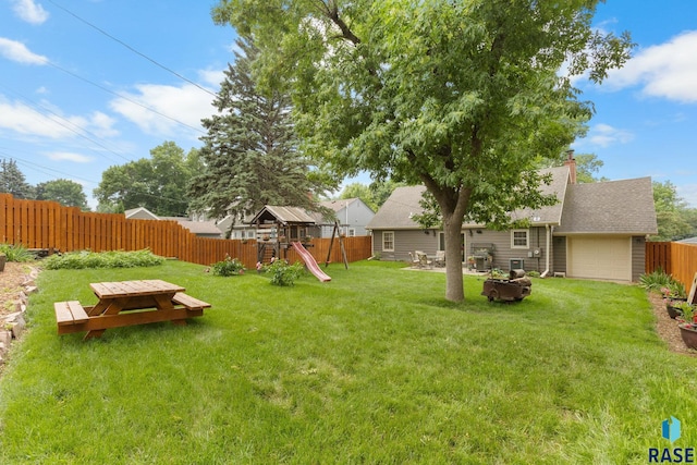 2424 S Main Ave, Sioux Falls, SD 57105 - fenced backyard featuring a playground and an attached garage