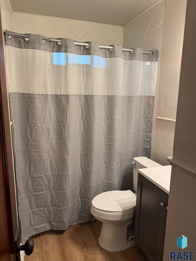 1330 W 14th St, Sioux Falls, SD 57104 - full bath featuring wood finished floors, vanity, and a shower with curtain
