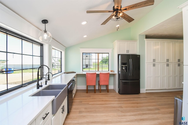 47138 293rd St, Beresford, SD 57004 - kitchen with refrigerator with ice dispenser, vaulted ceiling, recessed lighting, stainless steel dishwasher, and light wood-style floors