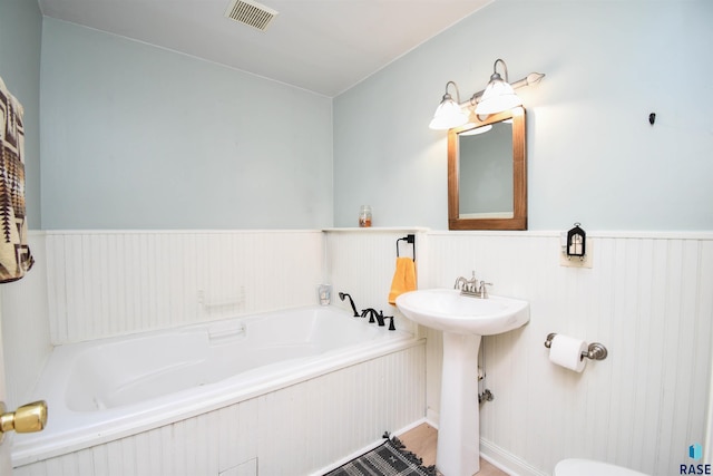47138 293rd St, Beresford, SD 57004 - bathroom with a bath and wainscoting