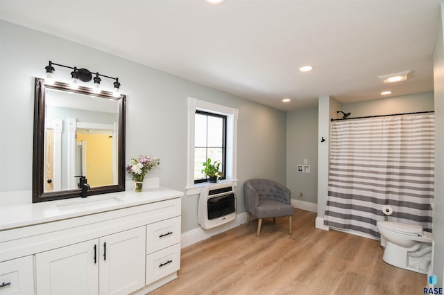47138 293rd St, Beresford, SD 57004 - bathroom featuring heating unit, vanity, wood finished floors, recessed lighting, and a shower with shower curtain