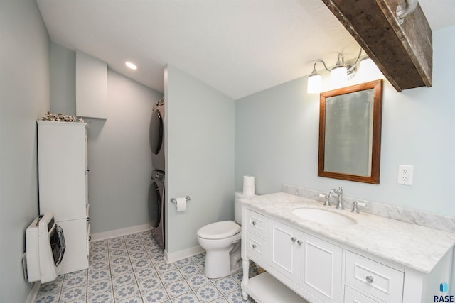 47138 293rd St, Beresford, SD 57004 - full bathroom featuring stacked washer / drying machine, vanity, heating unit, and vaulted ceiling
