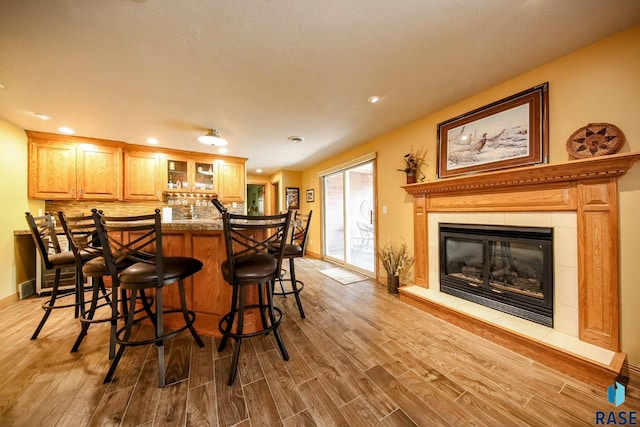 6811 E Split Rock Cir, Sioux Falls, SD 57110 - indoor bar with wood finished floors, recessed lighting, a fireplace, and tasteful backsplash