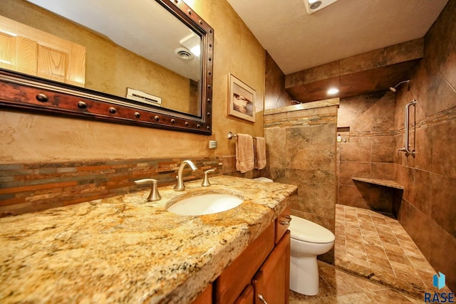 6811 E Split Rock Cir, Sioux Falls, SD 57110 - bathroom with vanity, tiled shower, and tile walls