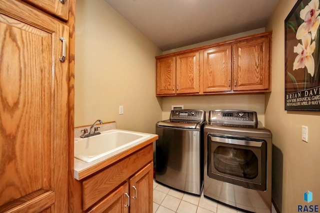 6811 E Split Rock Cir, Sioux Falls, SD 57110 - laundry room featuring washer and clothes dryer, cabinet space, and light tile patterned floors