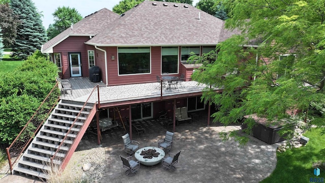 6811 E Split Rock Cir, Sioux Falls, SD 57110 - back of house featuring a wooden deck, stairs, an outdoor fire pit, and roof with shingles