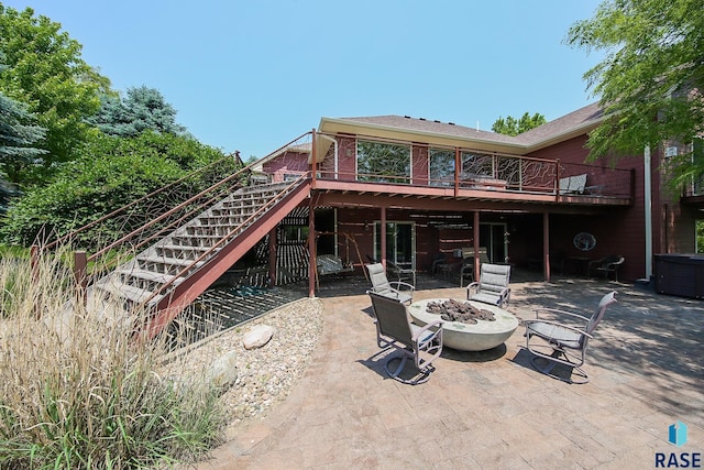 6811 E Split Rock Cir, Sioux Falls, SD 57110 - back of house with a fire pit, a patio, stairs, and a wooden deck