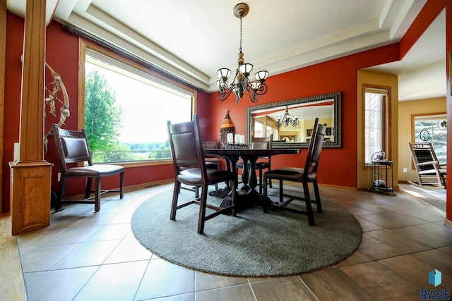 6811 E Split Rock Cir, Sioux Falls, SD 57110 - dining area with a chandelier, light tile patterned floors, and a raised ceiling