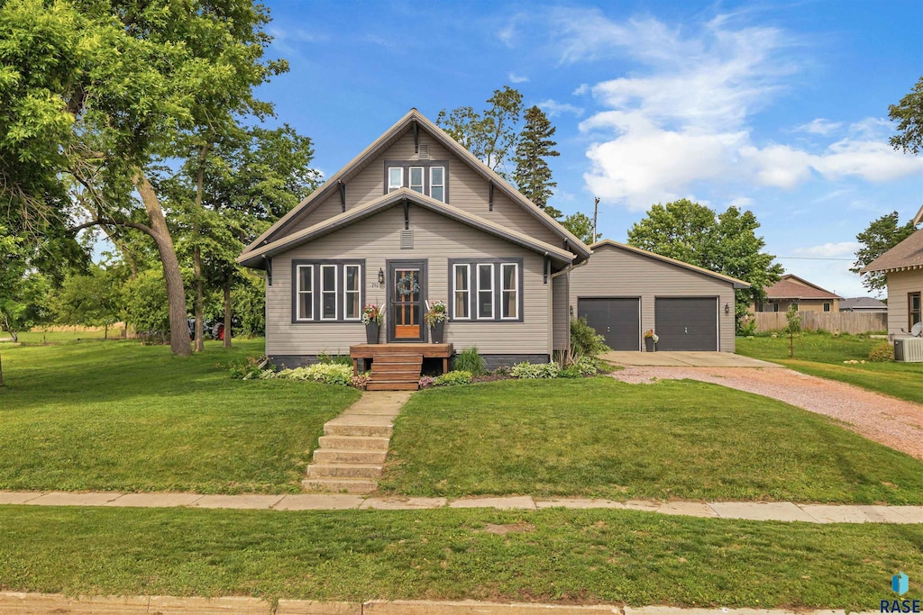 701 S Main Ave, Colton, SD 57018 - view of front of property with dirt driveway, an outdoor structure, a garage, and a front yard