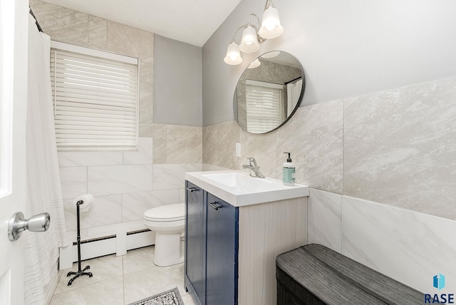 2109 W 37th St, Sioux Falls, SD 57105 - bathroom featuring a baseboard heating unit, tile walls, vanity, and tile patterned flooring