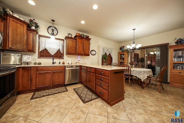 212 S Augusta Ave, Brandon, SD 57005 - kitchen featuring appliances with stainless steel finishes, a peninsula, a chandelier, light countertops, and pendant lighting