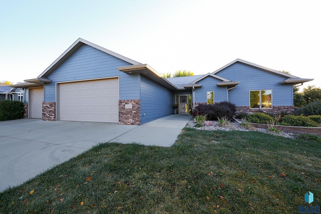212 S Augusta Ave, Brandon, SD 57005 - ranch-style home featuring brick siding, an attached garage, driveway, and a front yard