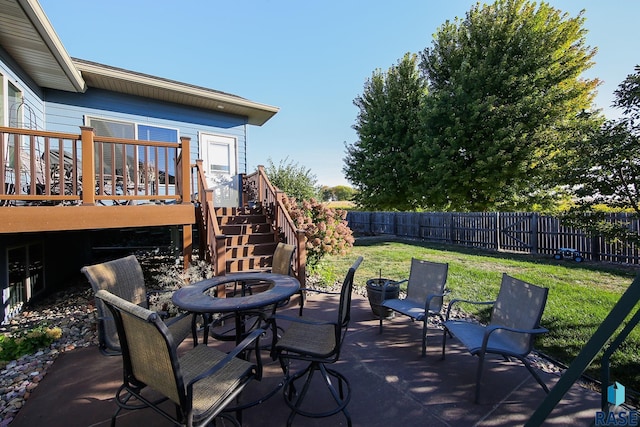 212 S Augusta Ave, Brandon, SD 57005 - fenced backyard featuring stairs, an outdoor fire pit, a wooden deck, and a patio