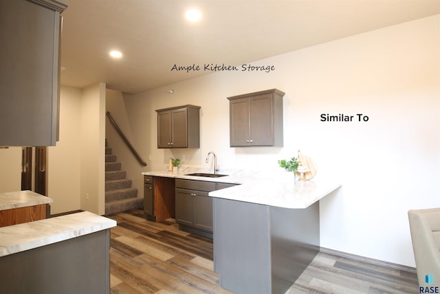7713 S Townsley Ave Unit 5, Sioux Falls, SD 57108 - kitchen with wood finished floors, a peninsula, light countertops, and recessed lighting