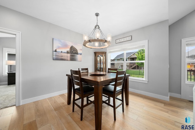 920 S Torrey Pine Ln, Sioux Falls, SD 57110 - dining room featuring a chandelier, light wood-style floors, and plenty of natural light